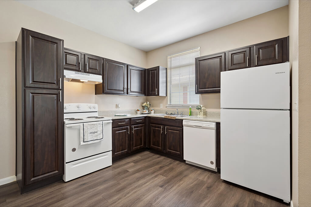 A kitchen with dark cabinets at the Fountains at Tidwell Apartments & The Enclave in Houston, Texas.